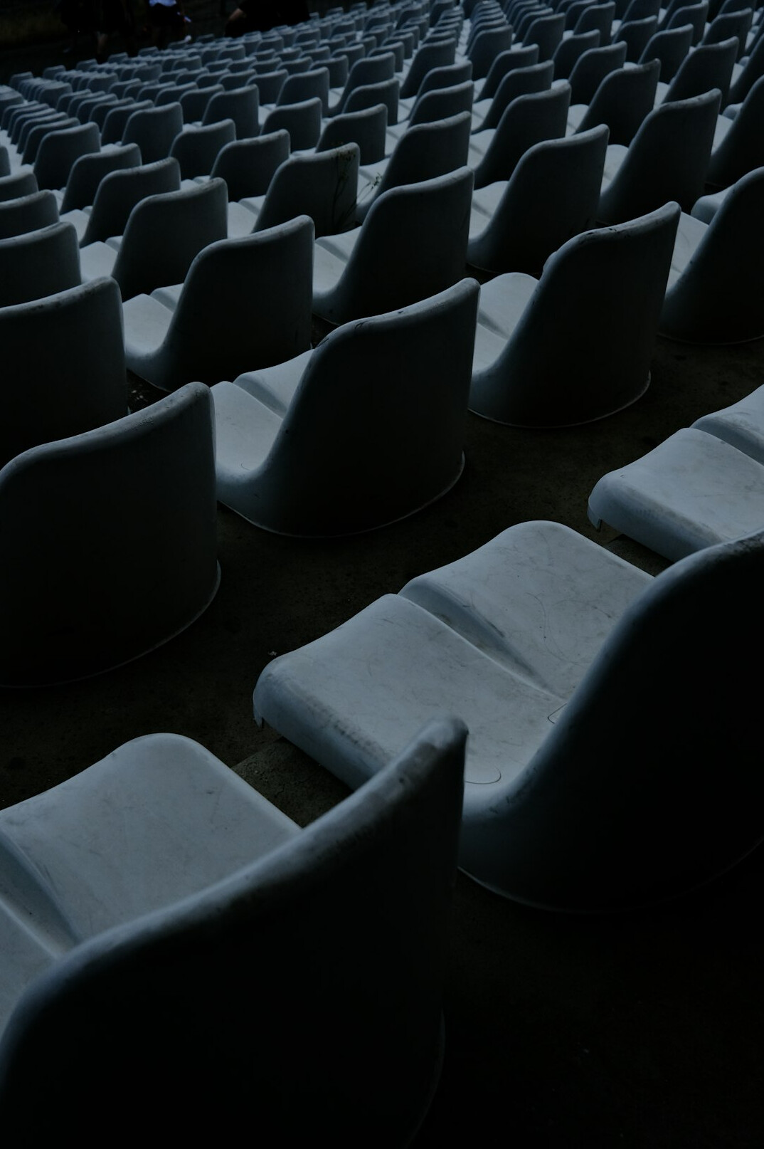 Empty theater seats in dim ambient light