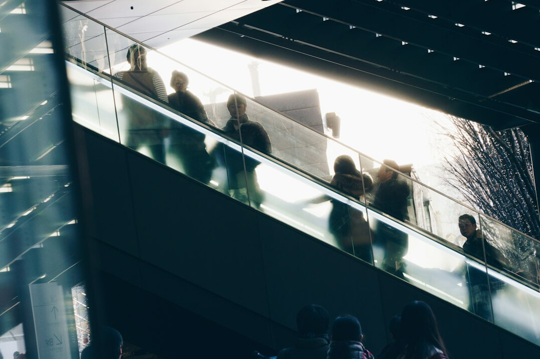 Crowd of anonymous people seen from a distance in soft light